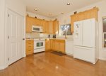 Sunny fully equipped kitchen with seated dining